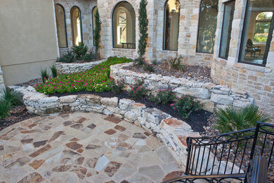 Inspiration for a retaining wall landscape in Austin.