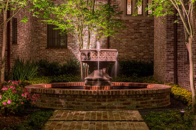 Photo of a large traditional courtyard water fountain landscape in Houston.