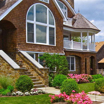 This is an example of a traditional full sun front yard flower bed in New York.