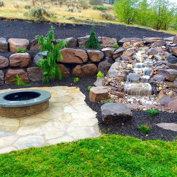 Huntsville stone patio, waterfall, and gas fire pit