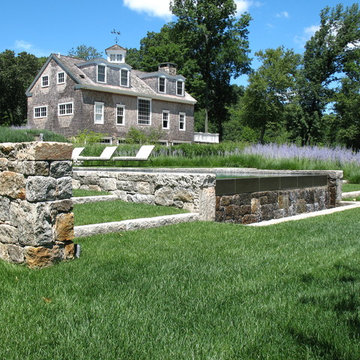 Infinity edge pool, stone walls, perennials and lawn
