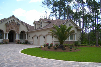 Inspiration for a large traditional front yard brick driveway in Jacksonville.