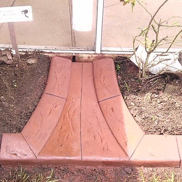 integrated splash blocks into curb to allow water drainage from down spouts and