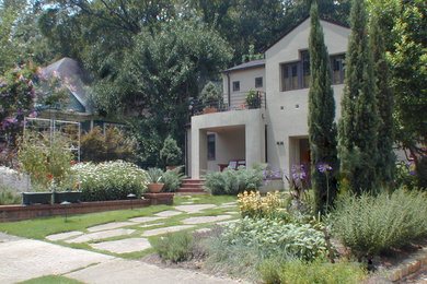 This is an example of a small modern full sun front yard stone landscaping in Atlanta for summer.