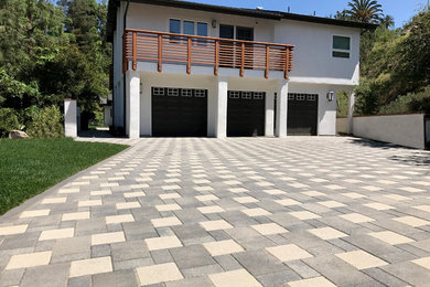 Photo of a modern front yard concrete paver driveway in Orange County.