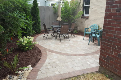 Photo of a small traditional backyard brick landscaping in Other.