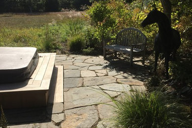 This is an example of a contemporary partial sun backyard stone landscaping in Boston for summer.