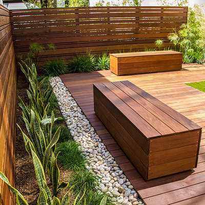 Photo of a large contemporary drought-tolerant and full sun backyard landscaping in Orange County with decking.