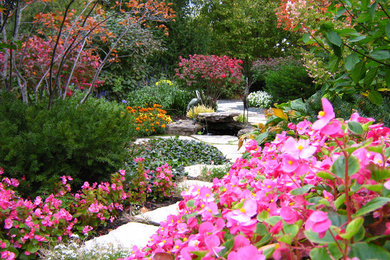 Design ideas for a mid-sized traditional partial sun front yard stone water fountain landscape in Chicago for fall.