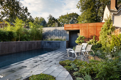 Design ideas for a mid-sized contemporary partial sun front yard stone landscaping in Toronto for summer.