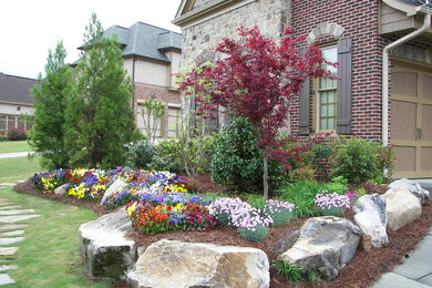 Photo of a large traditional full sun front yard concrete paver landscaping in Atlanta.