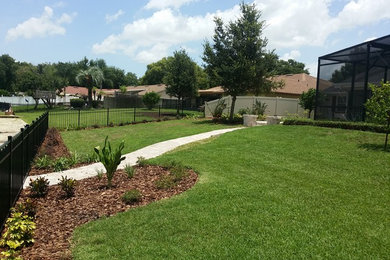 Design ideas for a full sun backyard brick landscaping in Orlando.