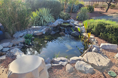 This is an example of a small mediterranean full sun backyard pond in Phoenix.