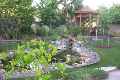 Photo of a mid-sized rustic full sun backyard landscaping in Los Angeles with decking for fall.