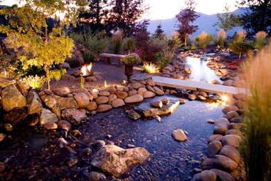 Design ideas for a mid-sized coastal drought-tolerant and full sun backyard stone water fountain landscape in Vancouver for summer.