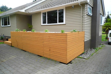 Inspiration for a medium sized contemporary front garden in Hamilton with a potted garden and decking.