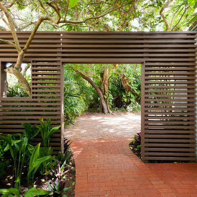 This is an example of a tropical side yard brick garden path in Portland.