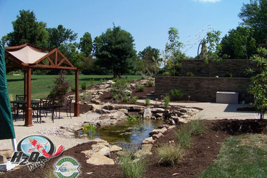 Design ideas for a large traditional full sun backyard concrete paver pond in Louisville.