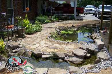 Design ideas for a large traditional full sun backyard stone pond in Louisville.