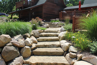 Design ideas for a rustic full sun hillside stone landscaping in Chicago.