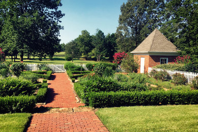 Photo of a farmhouse full sun backyard brick landscaping in Atlanta.