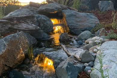 Inspiration for a huge modern drought-tolerant and full sun hillside gravel water fountain landscape in Sacramento for spring.