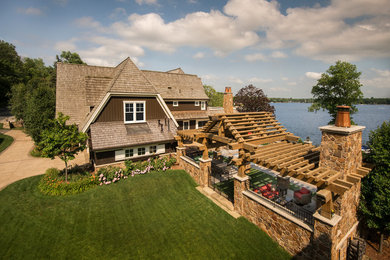 Photo of a classic side driveway partial sun garden in Minneapolis with a fire feature and concrete paving.