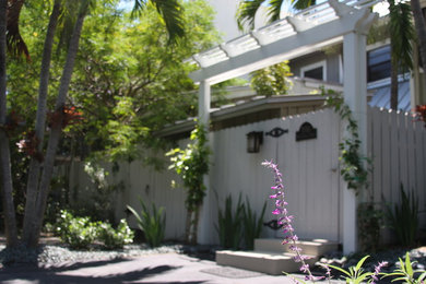 This is an example of a small shabby-chic style full sun front yard gravel garden path in Miami for summer.