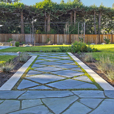 Inspiration for a mediterranean backyard stone landscaping in Other.