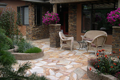 Inspiration for a mid-sized traditional partial sun backyard stone formal garden in Calgary.