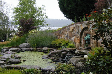 Inspiration for a mid-sized traditional drought-tolerant and partial sun backyard stone water fountain landscape in Baltimore for summer.
