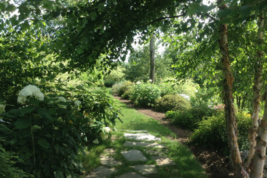 This is an example of a large farmhouse backyard garden path in Burlington.