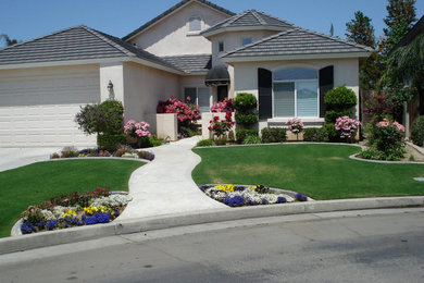 Photo of a mid-sized traditional full sun front yard concrete paver driveway in Other.