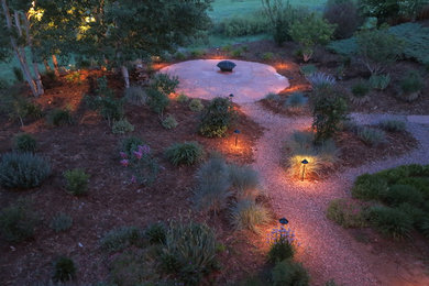 Photo of a large rustic back garden in Denver with a fire feature and gravel.