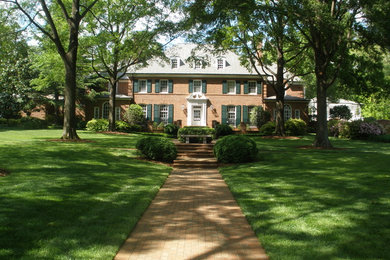 Design ideas for a huge traditional partial sun front yard brick landscaping in Raleigh.