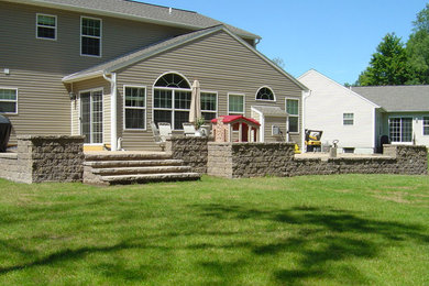 This is an example of a large traditional shade backyard concrete paver landscaping in New York for spring.