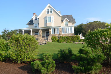 Photo of a large traditional front yard formal garden in Portland Maine.