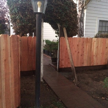 Landscape renovation with retaining wall and fence