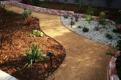 Design ideas for a medium sized front xeriscape full sun garden for summer in Los Angeles with a garden path and brick paving.