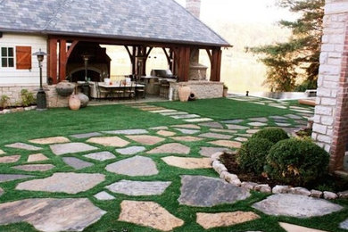 Diseño de jardín de estilo americano de tamaño medio en patio trasero con jardín francés, exposición total al sol y adoquines de piedra natural