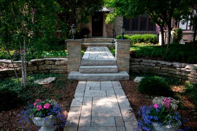 Photo of a mid-sized front yard stone garden path in Milwaukee.