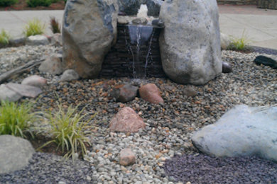 Design ideas for a large full sun front yard concrete paver water fountain landscape in DC Metro.