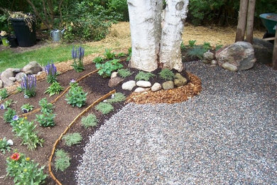 Inspiration for a large traditional partial sun backyard mulch garden path in Other.