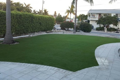 Design ideas for a mid-sized modern partial sun front yard concrete paver landscaping in Tampa for summer.