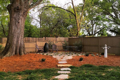Photo of a large traditional partial sun side yard concrete paver garden path in Other.