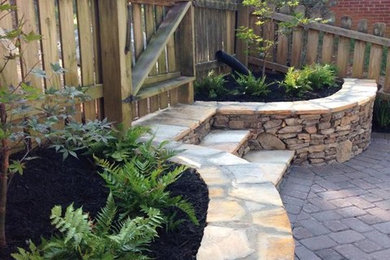 Design ideas for a mid-sized traditional full sun backyard stone garden path in Other.