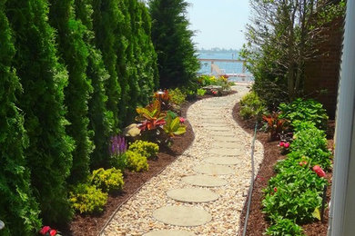 Photo of a mid-sized transitional full sun courtyard brick garden path in New York for summer.