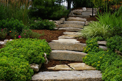 This is an example of a mid-sized traditional partial sun backyard stone garden path in Toronto for spring.