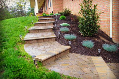 Inspiration for a mid-sized traditional side yard concrete paver landscaping in Other.