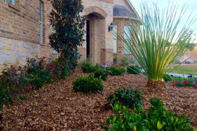 This is an example of a large southwestern drought-tolerant and full sun side yard mulch landscaping in Dallas.